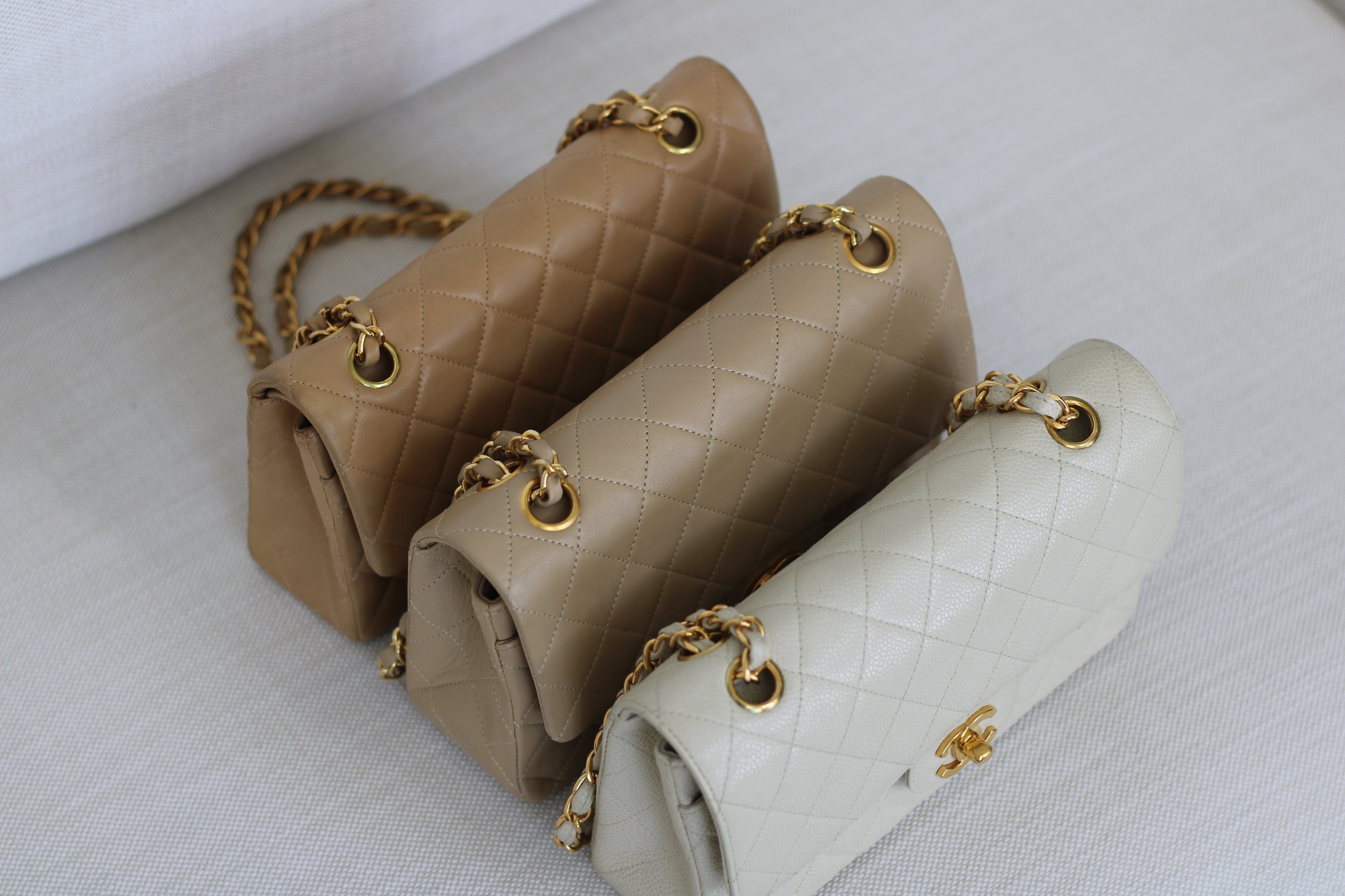 Luxxediton Classics Collection showing 3 Chanel bags in white, beige, and tan.