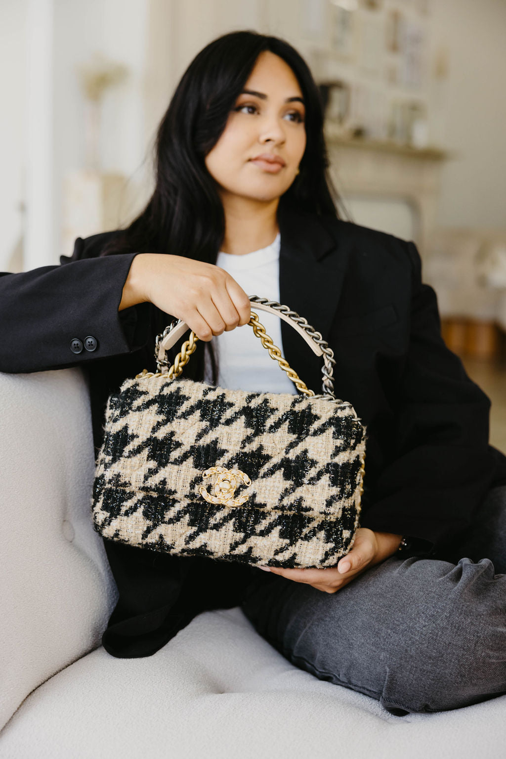 A beautiful woman holding a Luxury Chanel Bag for Consignment & Resale