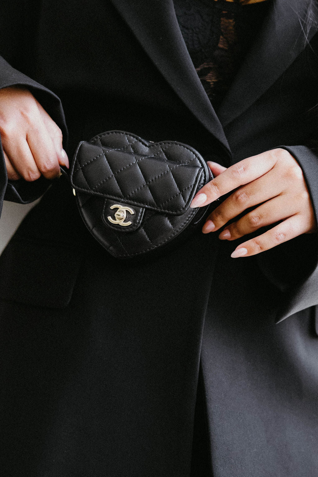A designer black leather Chanel belt bag for Luxury Bag Consignment & Resale